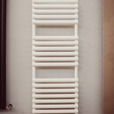 white colored tubular heated towel rail orbite graziano radiators